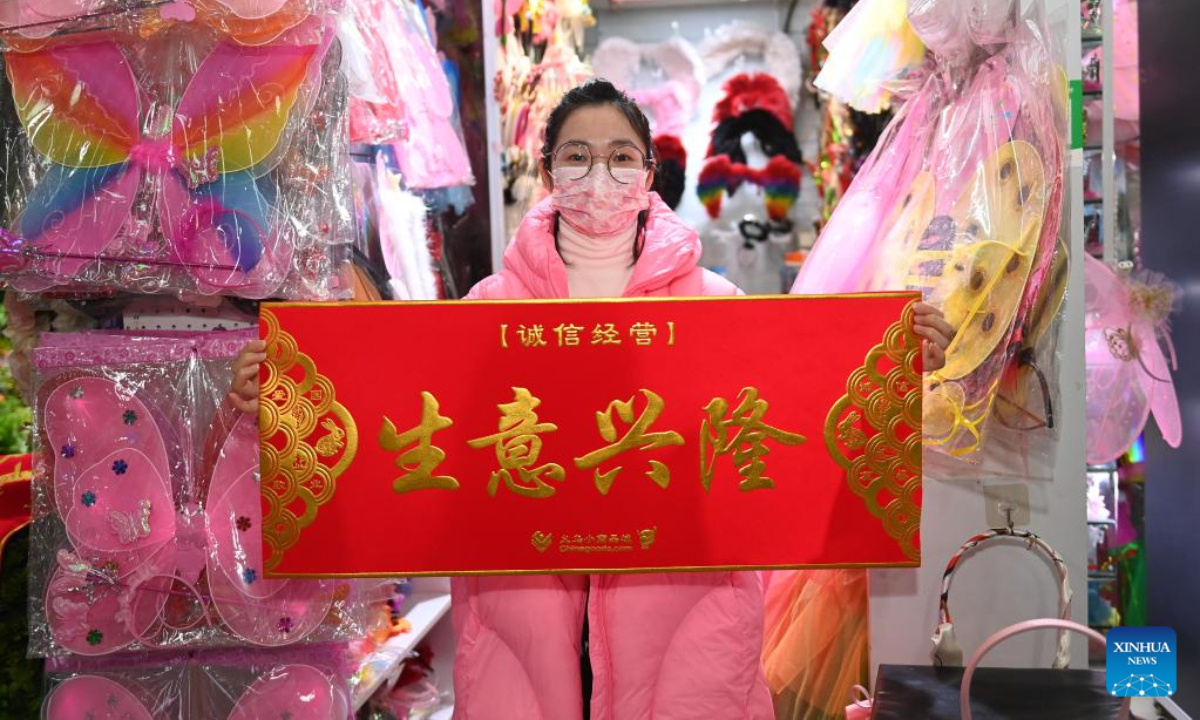A merchant shows a banner written