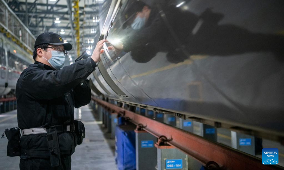 A worker examines a train at a maintenance base in Wuhan, central China's Hubei Province, Jan 6, 2023. Photo:Xinhua