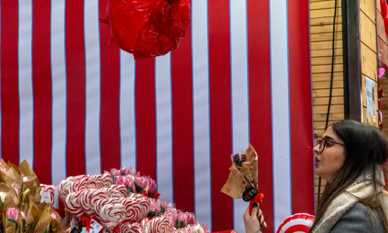A visitor shops at a stand of the 4th Chocolate Fest in Athens, Greece, Feb. 11, 2023. Photo: Xinhua