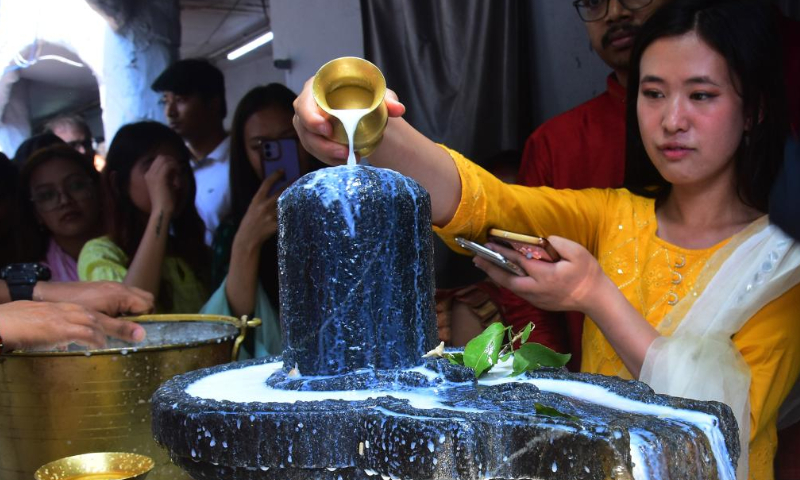 An Indian Hindu devotee pours milk on Shiva linga on the occasion of Maha Shivaratri festival, in Bengaluru, India, Feb. 18, 2023. Maha Shivaratri is a Hindu festival celebrated annually in honor of Lord Shiva. Photo: Xinhua