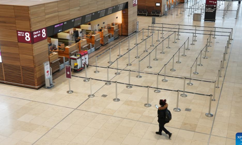 A woman walks in a terminal of Berlin Brandenburg Airport in Schoenefeld, Germany, Jan. 25, 2023. All passenger flights at Berlin Brandenburg Airport were canceled or delayed on Wednesday due to a strike by airport workers, estimated to affect about 35,000 passengers. Photo: Xinhua