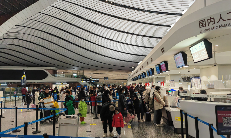 Passengers line to check in at Beijing Daxing International Airport on January 11, 2023. Photo: VCG