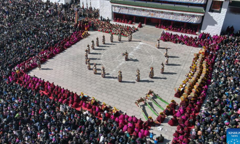This aerial photo taken on Feb. 4, 2023 shows masked monks performing religious dance during a ritual at the Labrang Monastery in Xiahe County, northwest China's Gansu Province. The ritual was held here on Saturday to pray for good luck in the new year.  Photo: Xinhua