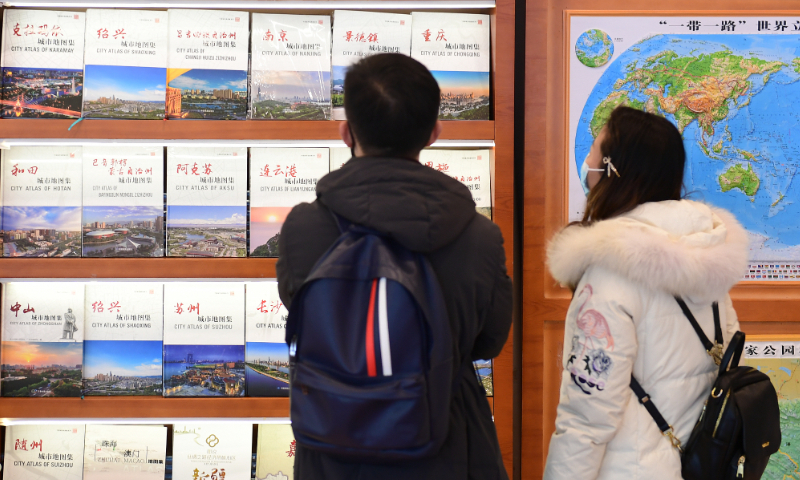 Local residents visit a map-themed bookstore in Xicheng district, Beijing on December 7, 2021. Photo: VCG