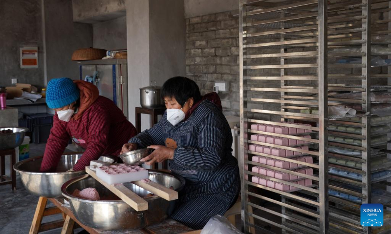 Residents make traditional desserts for the Spring Festival in Liantang Town of Qingpu District, east China's Shanghai, Jan. 17, 2023. This year's Spring Festival, the Chinese traditional lunar New Year, starts from Jan. 22. (Xinhua/Liu Ying)
