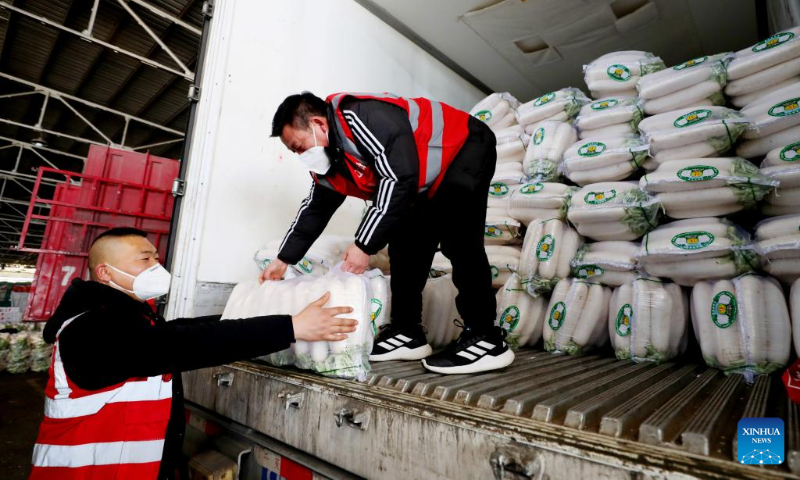 Wholesalers restock white radishes ahead of the Spring Festival at the Jiangqiao vegetable wholesale market in east China's Shanghai Jan. 17, 2023. This year's Spring Festival, the Chinese traditional lunar New Year, starts from Jan. 22. (Xinhua/Fang Zhe)