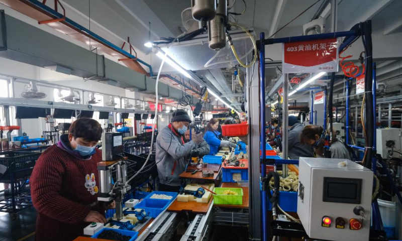 Staff members make electrical equipment at an electrical appliance company in Yuxin Town of Nanhu District, Jiaxing, east China's Zhejiang Province, Jan. 26, 2023. Many companies in Nanhu District of Jiaxing have sped up production during the Spring Festival holiday to ensure delivery of orders, while offering cash gifts and other rewards for employees. Photo: Xinhua