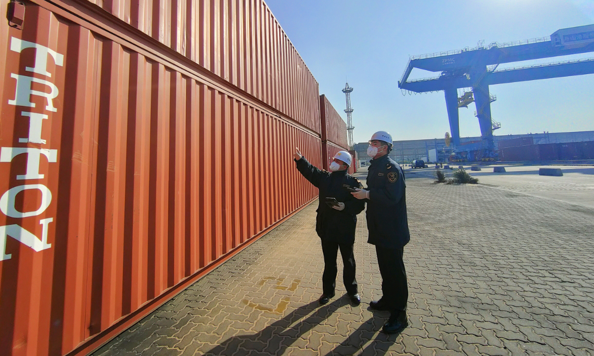 Local customs officials inspect containers at the port in Zhoushan, East China's Zhejiang Province. Photo: Courtesy of Zhoushan Customs