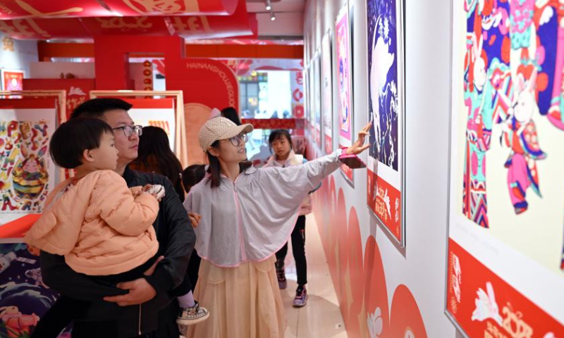 Tourists visit an exhibition at the Qilou ancient street during the Spring Festival holiday in Haikou, south China's Hainan Province, Jan. 27, 2023. Photo: Xinhua
