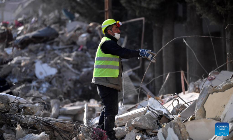 A man stands amid earthquake debris in Antakya in the southern province of Hatay, Türkiye, Feb. 12, 2023. Photo: Xinhua