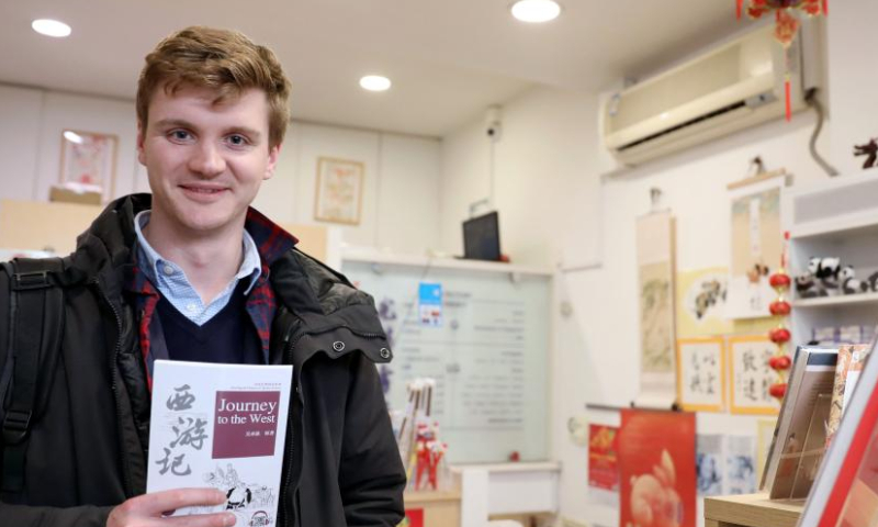 Jack Flowers shows his newly bought simplified version of Journey to the West, one of the four classics of Chinese literature, at the Guanghwa Bookshop in London, Britain, Jan. 24, 2023. Photo: Xinhua