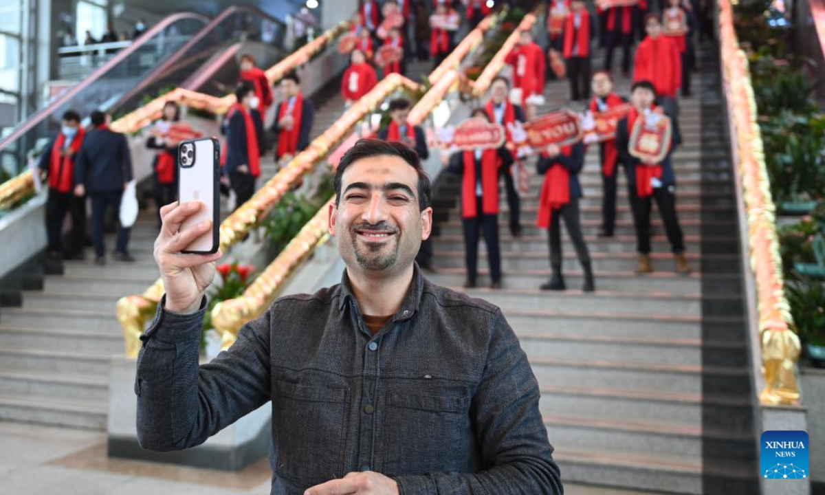 An Iraqi businessman takes a selfie while watching celebrations to welcome the first business day in the Year of the Rabbit at the International Trade Market in Yiwu City, east China's Zhejiang Province, Feb 2, 2023. About 75,000 merchants at the Yiwu International Trade Market on Thursday welcomed their first business day in the Year of the Rabbit. Photo:Xinhua