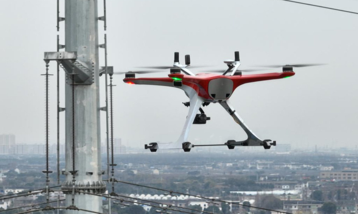 An unmanned drone with centimeter-level high-precision positioning capabilities inspects the automatic transmission lines of the electric transmission towers in east China's Jiangsu Province, Dec 29, 2022. Photo:Xinhua