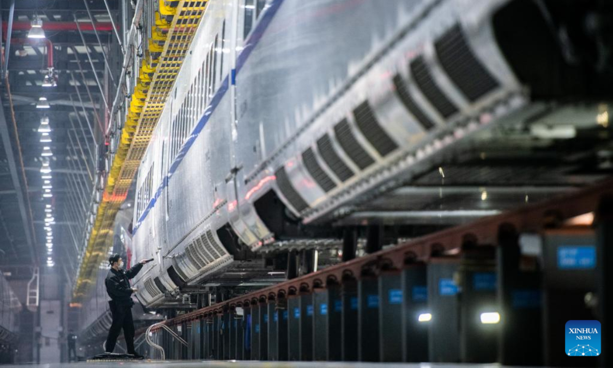 A worker examines a train at a maintenance base in Wuhan, central China's Hubei Province, Jan 6, 2023. Photo:Xinhua
