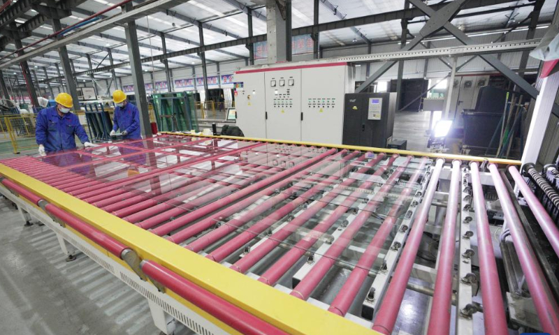 Employees work on a production line at a glass factory in Jiamusi, northeast China's Heilongjiang Province, Feb. 17, 2023. Photo: Xinhua