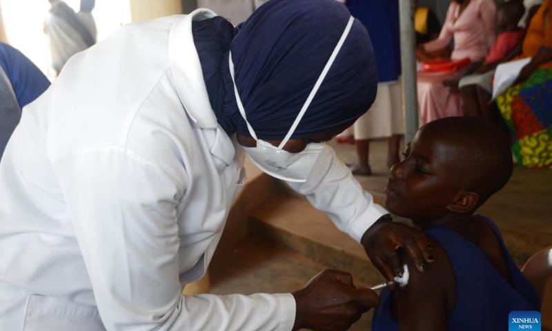 A health worker immunizes a girl with a Human Papilloma Virus vaccine during a World Cancer Day event in Mukono, Uganda, Feb. 4, 2023. Hundreds of people on Saturday turned up for free cancer screening during an event to mark World Cancer Day in the central Ugandan district of Mukono.Photo: Xinhua