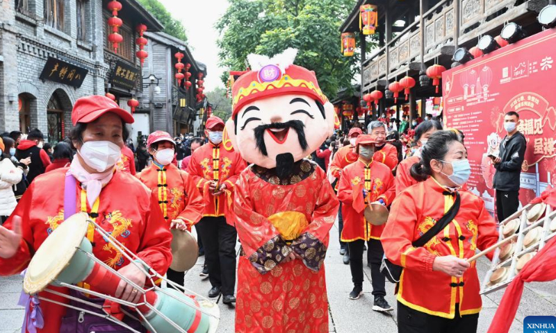 A staff member in the costume of the God of Wealth takes part in a parade at Sanfangqixiang (Three Lanes and Seven Alleys), an ancient block in downtown Fuzhou, southeast China's Fujian Province, Jan. 26, 2023. Ceremonies were held to welcome the God of Wealth as a tradition on the fifth day of the Chinese Lunar New Year, which falls on Thursday this year. Photo: Xinhua