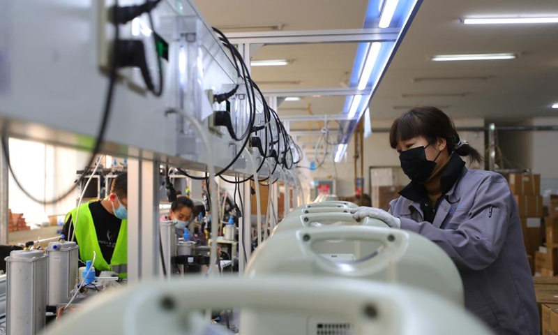 Employees of a medical enterprise work on the production line of oxygen concentrators in Shenyang, northeast China's Liaoning Province, Jan. 5, 2023. (Xinhua/Yang Qing)