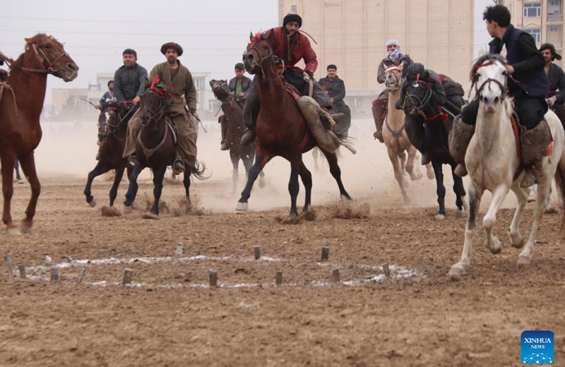 Afghan horse riders compete in a Buzkashi game in Balkh province, Afghanistan, Jan. 6, 2023. Buzkashi, or goat grabbing, is a kind of traditional sport in Afghanistan. In this game, two teams of horsemen compete to grab a goat carcass and carry it through a goal. (Photo by M Fardin Nawrozi/Xinhua)