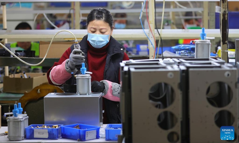 An employee of a medical enterprise works on the production line of oxygen concentrators in Shenyang, northeast China's Liaoning Province, Jan. 5, 2023. (Xinhua/Yang Qing)