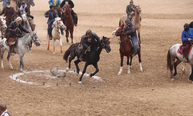 Afghan horse riders compete in a Buzkashi game in Balkh province, Afghanistan, Jan. 6, 2023. Buzkashi, or goat grabbing, is a kind of traditional sport in Afghanistan. In this game, two teams of horsemen compete to grab a goat carcass and carry it through a goal. (Photo by M Fardin Nawrozi/Xinhua)