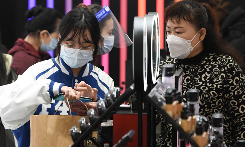 Tourists select cosmetics at Haikou Riyue Plaza Duty Free Shop in Haikou, south China's Hainan Province, Jan. 8, 2023. (Xinhua/Yang Guanyu)