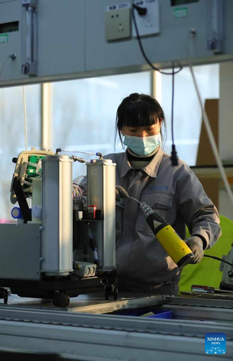 An employee of a medical enterprise works on the production line of oxygen concentrators in Shenyang, northeast China's Liaoning Province, Jan. 5, 2023. (Xinhua/Yang Qing)