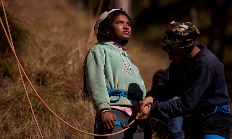 A visually impaired person gets ready for a rock climbing event organized for the first time for visually impaired people on the outskirts of Kathmandu, Nepal on Jan. 7, 2023. (Photo by Sulav Shrestha/Xinhua)