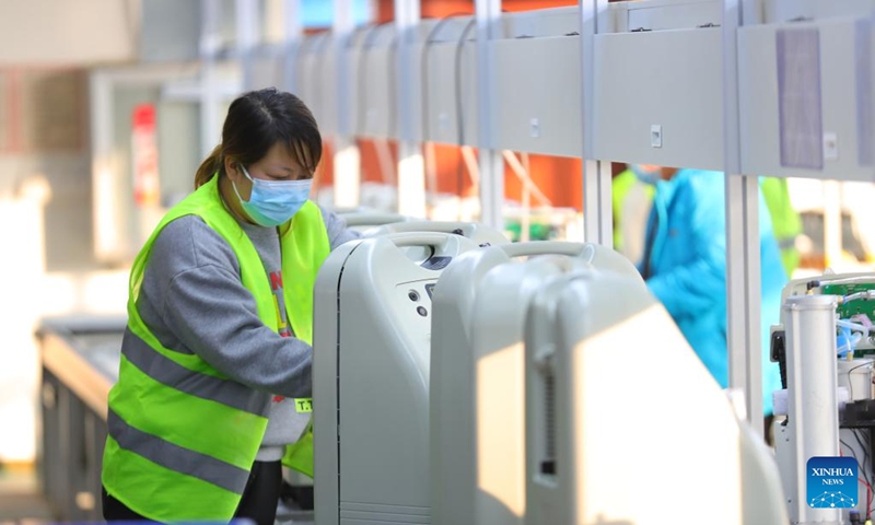 An employee of a medical enterprise works on the production line of oxygen concentrators in Shenyang, northeast China's Liaoning Province, Jan. 5, 2023. (Xinhua/Yang Qing)