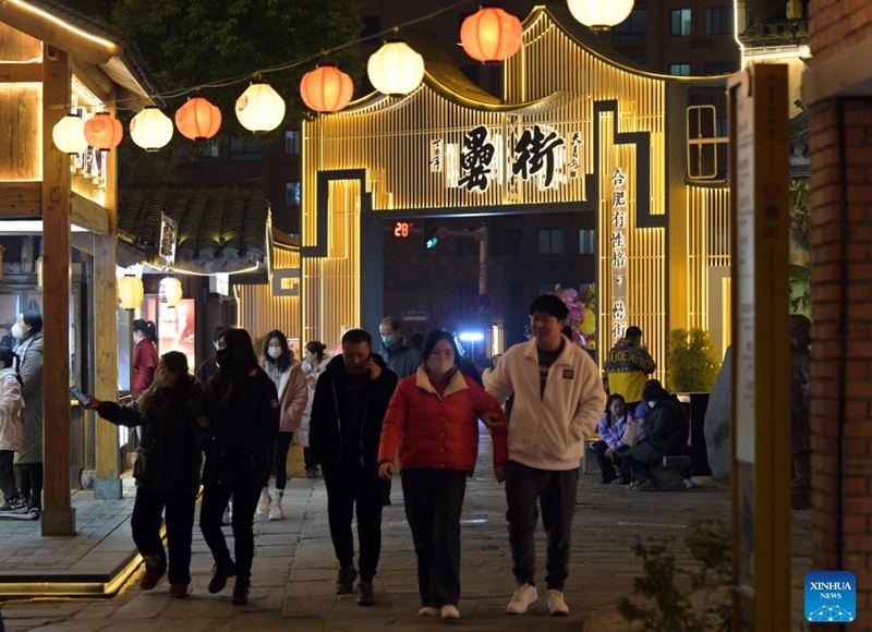 People walk on Leijie street, a commercial area famous for its night economy, in Hefei, east China's Anhui Province, Jan. 6, 2023. The night-time consumption in the commercial area has resumed in an orderly manner recently. (Xinhua/Zhou Mu)