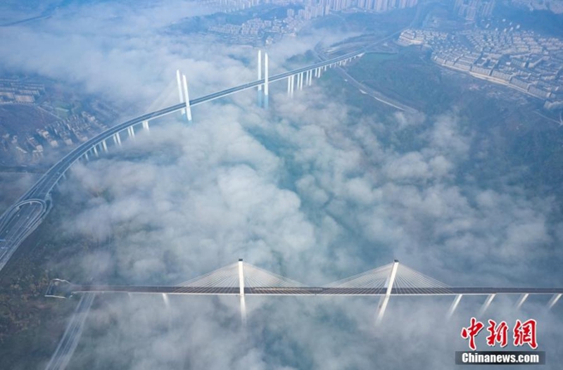 A metro train runs in advection fog shrouded Caijia Rail Transit Bridge in Chongqing, creating an amazing scenery of train running over the could, Jan. 7, 2023. (Photo provided to China News Service)