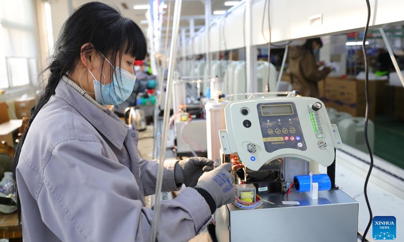 An employee of a medical enterprise works on the production line of oxygen concentrators in Shenyang, northeast China's Liaoning Province, Jan. 5, 2023. (Xinhua/Yang Qing)