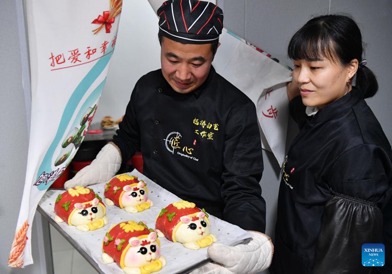 A pastry chef demonstrates rabbit-inspired steamed buns in Luoyang, central China's Henan Province, Jan. 13, 2023. A pastry workshop in Luoyang has introduced rabbit-inspired steamed buns in celebration of the upcoming Chinese Year of the Rabbit. (Xinhua/Li Jianan)