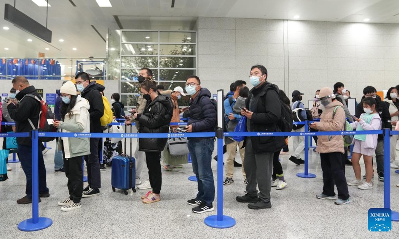 Passengers queue up to go through entry procedures at Shanghai Pudong International Airport in east China's Shanghai, Jan. 8, 2023. From Sunday, China starts managing COVID-19 with measures designed for combating Class B infectious diseases, instead of Class A infectious diseases. (Xinhua/Ding Ting)