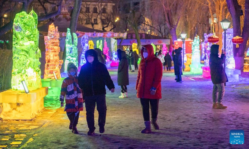 People visit an ice lantern fair in Harbin, northeast China's Heilongjiang Province, Jan. 14, 2023. Harbin is famous for its rich ice and snow resources. This winter, the city opened three ice and snow-themed parks, launched 12 ice and snow experience products and 10 such tourism routes, and created more than 100 related activities to promote the development of winter tourism, culture, fashion and sports. (Xinhua/Xie Jianfei)