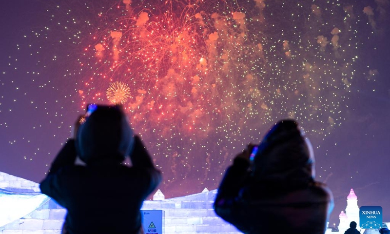 People watch a fireworks show in the Harbin Ice-Snow World theme park in Harbin, northeast China's Heilongjiang Province, Jan. 5, 2023. Harbin is famous for its rich ice and snow resources. This winter, the city opened three ice and snow-themed parks, launched 12 ice and snow experience products and 10 such tourism routes, and created more than 100 related activities to promote the development of winter tourism, culture, fashion and sports. (Xinhua/Xie Jianfei)