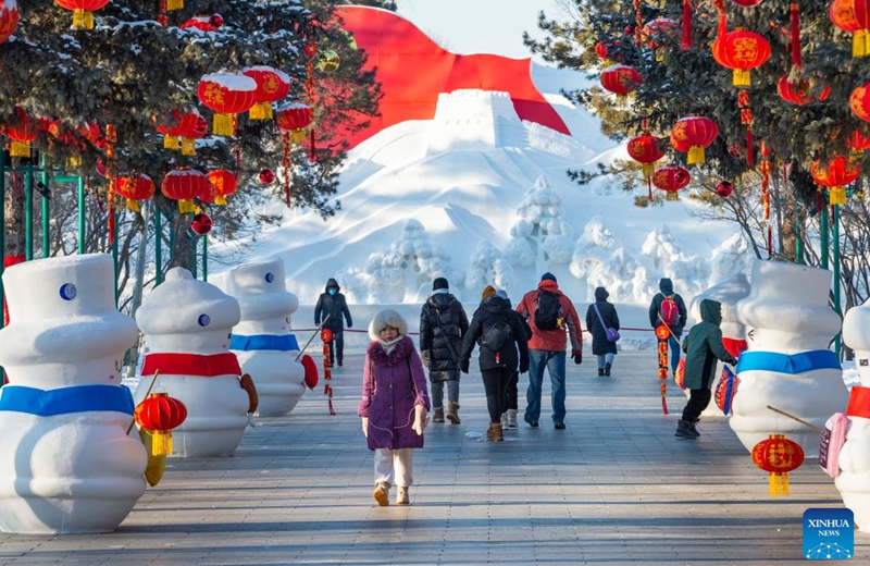People visit the Taiyangdao Island International Snow Sculpture Expo in Harbin, northeast China's Heilongjiang Province, Jan. 3, 2023. Harbin is famous for its rich ice and snow resources. This winter, the city opened three ice and snow-themed parks, launched 12 ice and snow experience products and 10 such tourism routes, and created more than 100 related activities to promote the development of winter tourism, culture, fashion and sports. (Xinhua/Xie Jianfei)