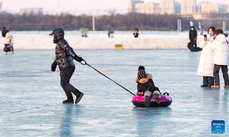 People have fun at the Ice and Snow Carnival park on the Songhua River in Harbin, northeast China's Heilongjiang Province, Jan. 14, 2023. Harbin is famous for its rich ice and snow resources. This winter, the city opened three ice and snow-themed parks, launched 12 ice and snow experience products and 10 such tourism routes, and created more than 100 related activities to promote the development of winter tourism, culture, fashion and sports. (Xinhua/Xie Jianfei)