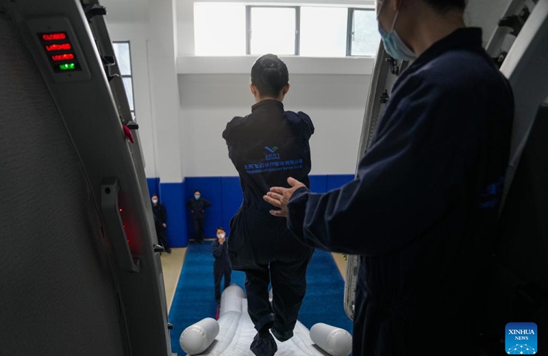 Flight attendants of China Eastern Airlines' C919 attend a training course by COMAC Shanghai Aircraft Customer Service Co., Ltd. in Shanghai, east China, Jan. 6, 2023. Flight attendants of China Eastern Airlines have attended intensive training for the C919 to ensure smooth operation of the aircraft. (Xinhua/Ding Ting)