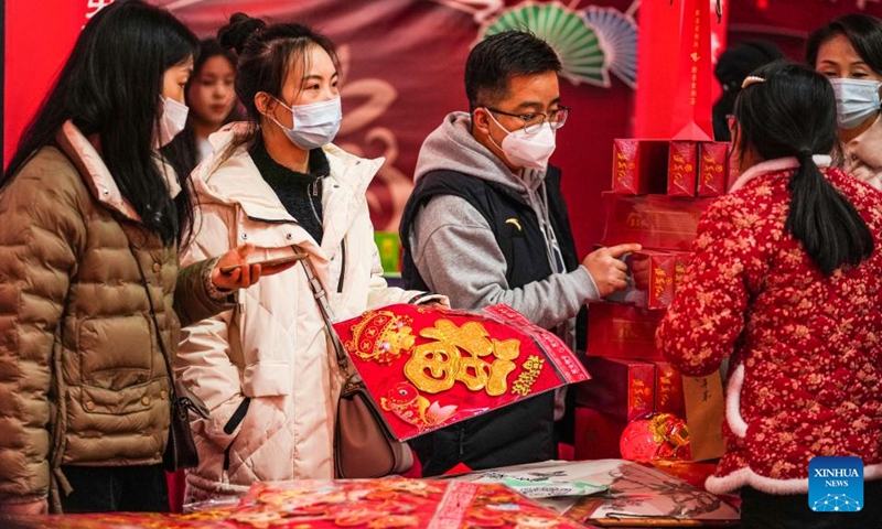 Residents select decorations for the upcoming Spring Festival at Lanhua Square in Nanming District of Guiyang City, southwest China's Guizhou Province, Jan. 14, 2023. (Xinhua/Tao Liang)