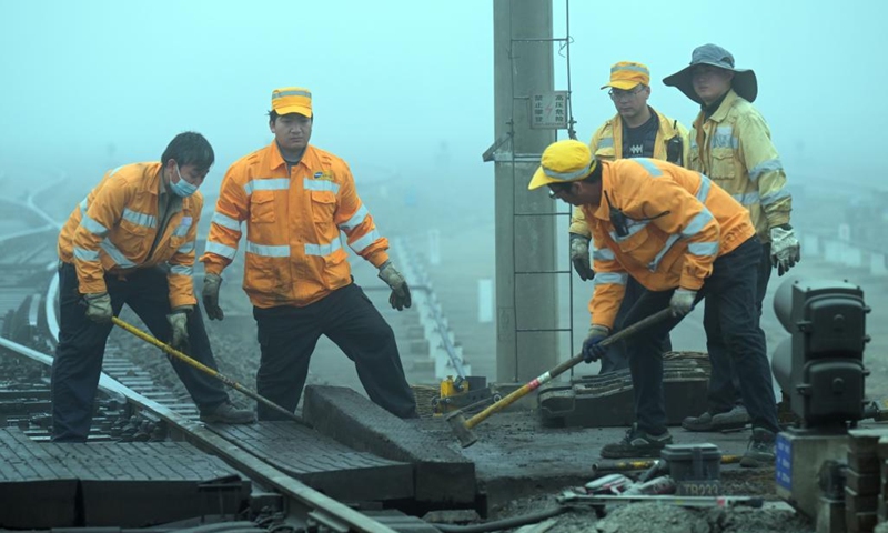 Workers carry out a maintenance task along a railway section at Hefei East Railway Station in Hefei, east China's Anhui Province, Jan. 13, 2023. The maintenance team under the Hefei branch of China Railway Shanghai Group Co., Ltd has been busy performing maintenance tasks in non-service hours to make sure that safe and smooth train rides are available to passengers during the Spring Festival travel rush. (Xinhua/Zhou Mu)