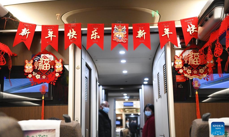This photo taken on Jan. 14, 2023 shows Spring Festival ornaments on train No.G9480 travelling from east China's Shanghai to Bozhou in east China's Anhui Province. The Hefei branch of China Railway Shanghai Bureau Group Co., Ltd. has added temporary night trains to meet the needs of travellers during the Spring Festival travel rush. (Xinhua/Zhang Duan)