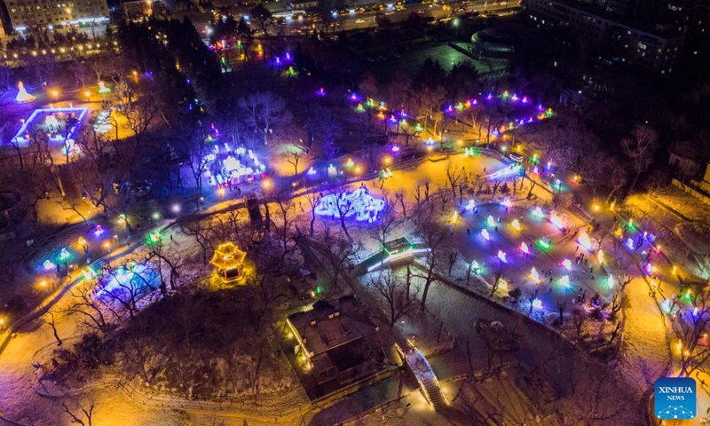 This aerial photo taken on Jan. 14, 2023 shows an ice lantern fair in Harbin, northeast China's Heilongjiang Province. Harbin is famous for its rich ice and snow resources. This winter, the city opened three ice and snow-themed parks, launched 12 ice and snow experience products and 10 such tourism routes, and created more than 100 related activities to promote the development of winter tourism, culture, fashion and sports. (Xinhua/Xie Jianfei)