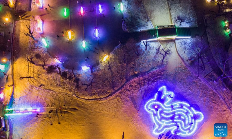 This aerial photo taken on Jan. 14, 2023 shows an ice lantern fair in Harbin, northeast China's Heilongjiang Province. Harbin is famous for its rich ice and snow resources. This winter, the city opened three ice and snow-themed parks, launched 12 ice and snow experience products and 10 such tourism routes, and created more than 100 related activities to promote the development of winter tourism, culture, fashion and sports. (Xinhua/Xie Jianfei)