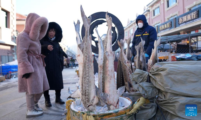 Customers select fish products at Dongji fish market, literally meaning the easternmost fish market, in Fuyuan City, northeast China's Heilongjiang Province, Jan. 9, 2023. As the Spring Festival approaches, Dongji fish market in Fuyuan has entered its peak season, with daily online sales exceeding 300,000 yuan (about 44,307 U.S. dollars).(Photo: Xinhua)