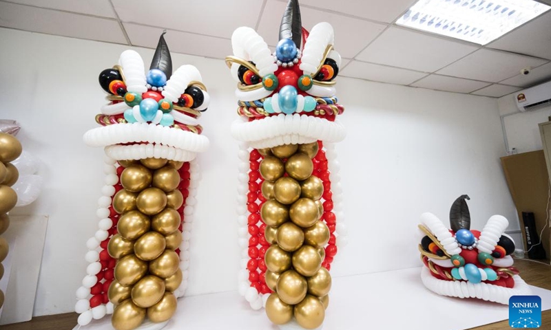 Lion dance balloon sculptures are seen in Syndy Tan Sing Yit's workshop near Kuala Lumpur, Malaysia, Dec. 31, 2022. Syndy Tan Sing Yit is a Malaysian balloon stylist who has been working on balloon modeling for more than a decade. She has created lion dance balloon sculptures by referring to lion dance graphics and pictures.(Photo: Xinhua)