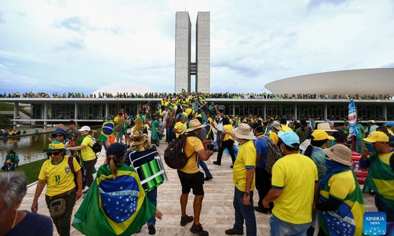 Protesters gather near Brazil's Congress building in Brasilia, Brazil, Jan. 8, 2023. Brazilian authorities have arrested at least 1,200 supporters of former President Jair Bolsonaro by Monday, and regained control of main government buildings here.(Photo: Xinhua)