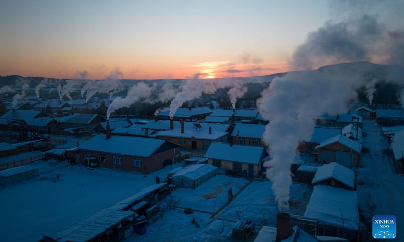 This aerial photo taken on Jan. 8, 2023 shows an early morning view of Beiji Village in Mohe, northeast China's Heilongjiang Province. Known as China's North Pole, Mohe has an annual ice and snow period of up to eight months, with the lowest temperature reaching minus 50 degrees Celsius. By virtue of its natural conditions, the city has developed a variety of winter tourism programs in recent years, attracting tourists to experience an extremely cold journey.(Photo: Xinhua)