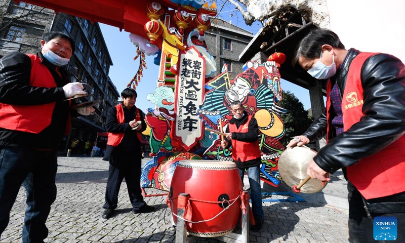 People play traditional Chinese musical instruments to celebrate the opening of a shopping festival in Pingyao Town of Yuhang District in Hangzhou City, east China's Zhejiang Province, Jan. 11, 2023. The shopping festival featuring local agricultural and cultural products kicked off here on Wednesday to warm up for the upcoming Chinese Lunar New Year.(Photo: Xinhua)