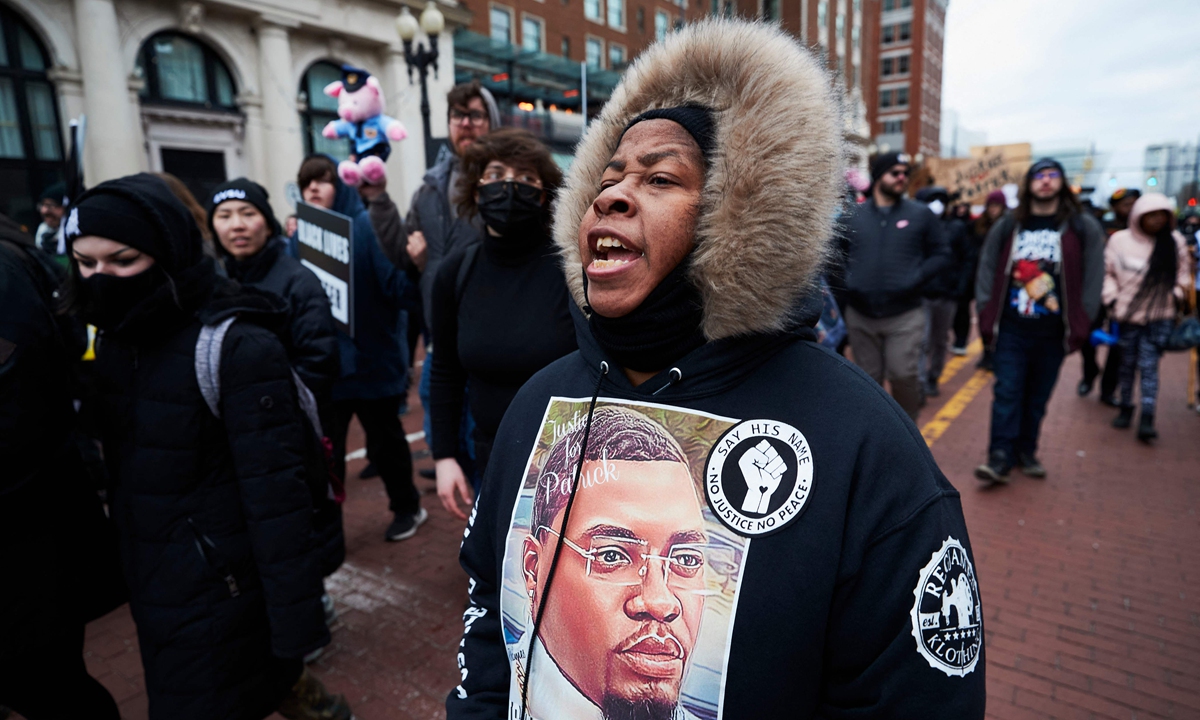 A woman wears a sweater with an image of Patrick Lyoya as protesters march for Lyoya, a Black man who was fatally shot by a police officer, in downtown Grand Rapids, Michigan, the US on April 16, 2022. Photo: VCG